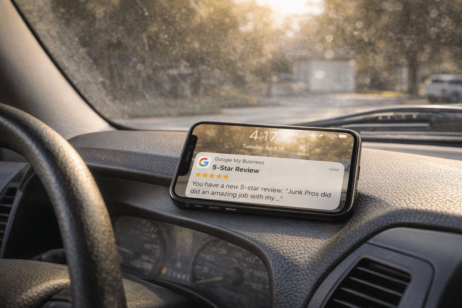 Smartphone on a truck dashboard showing a new 5-star Google review notification