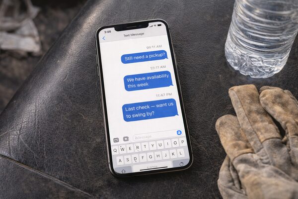 Phone and work gloves on truck seat